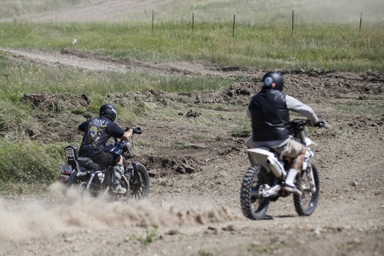 Harley racing a dirt bike during Sturgis Rally at the Buffalo Chip